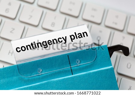 contingency plan is on a label of a blue hanging file. In the background a computer keyboard Royalty-Free Stock Photo #1668771022