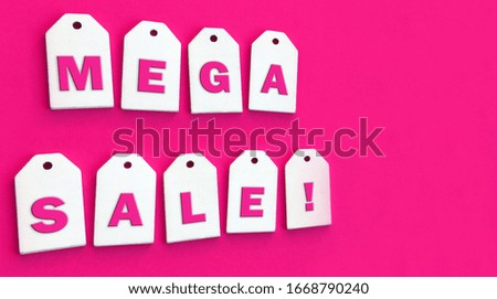 Nine white wooden tags with the word "mega sale" on a pink background. Copy spase. Sales concept.