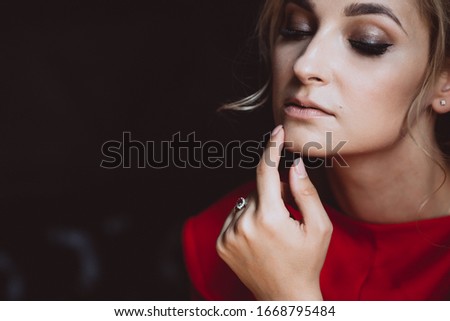 Close-up portrait of a beautiful romantic woman lady in a red dress. Soft selective focus. Beauty, fashion.