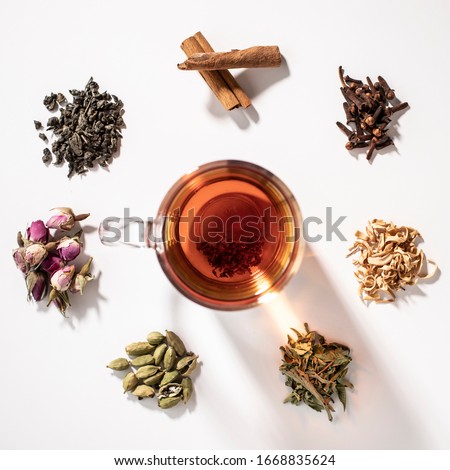 a cup of tea with colorful kinds of flowers and herbs