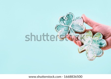 Three gingerbread in the navof of money on an abstract background of different colors. St. Patrick's Day