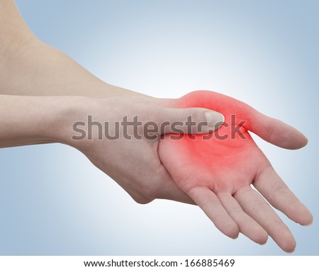 Acute pain in a woman palm. Female holding hand to spot of palm-ache. Concept photo with Color Enhanced blue skin with read spot indicating location of the pain. Isolation on a white background. 