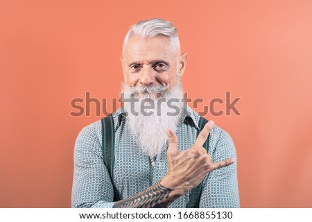 Senior man having fun posing in front camera - Happy mature male enjoying retired time - Elderly people lifestyle and hipster culture concept