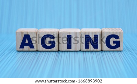 concept word aging on cubes on a striped blue background