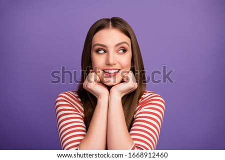 Closeup photo of attractive funny lady good mood cunning eyes look side empty space have tricky idea arms hold chin wear casual striped shirt isolated pastel purple color background