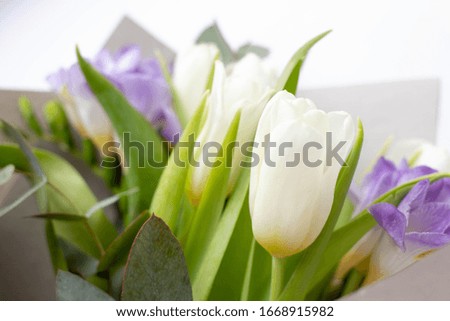 bouquet with white tulips, eucalyptus and lilac freesia