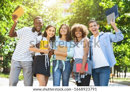 Students Community. Group Of College Friends Posing For Group Photo Outdoors, Holding Workbooks In Hands And Smiling, Empty Space