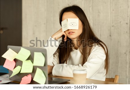 A lot of work concept. Tired freelancer sleeping at workplace with stickers on eyes Royalty-Free Stock Photo #1668926179