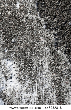 Background of old asphalt in the snow in winter, street road texture.