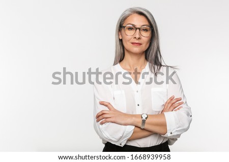 Image of adult mature woman with long gray hair wearing eyeglasses and office clothes isolated over white background Royalty-Free Stock Photo #1668939958