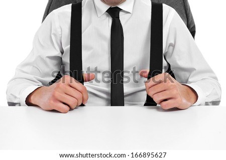 a businessman with suspenders sitting in a desk in the office