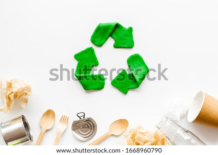 Green recycle icon near plastic, paper, glass waste on white background top-down copy space