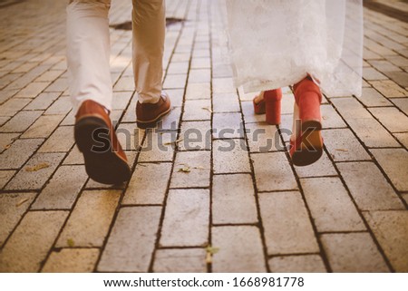 Close-up photo of the feet of the bride and groom. bride and groom in shoes.  vintage photo processing