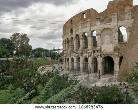 Top view of the Colosseum with a cloudy sky in the background Royalty-Free Stock Photo #1668983476