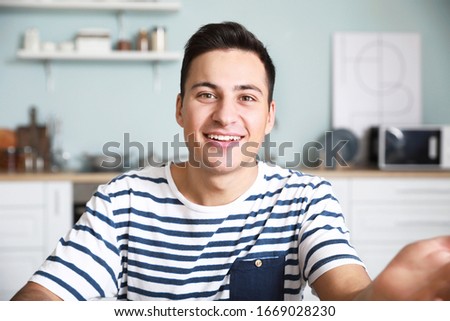 Young man using video chat at home Royalty-Free Stock Photo #1669028230
