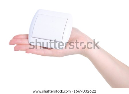 electric switch button in hand on white background isolation