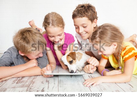 Children with tablet. Group kids playing