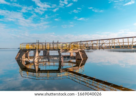 Picture of small dam on the river with beautiful reflection on the water