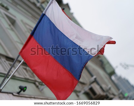Russian national flag blowing over the Moscow city street in spring day time.