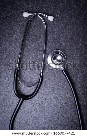 Medical concept, stethoscope on black surface