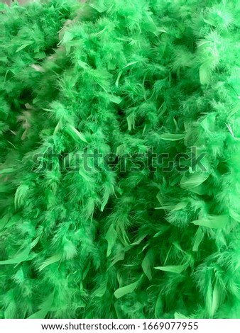 Closeup of a multitude of bright green feather boas for St Patrick's Day.  Freshness concept.