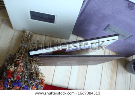 
album photo book with the inscription with a decor next to flowers, 
view from above