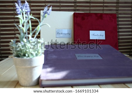 
many albums and photo books for sale, different cover colors, velor, leatherette and wood, close-up