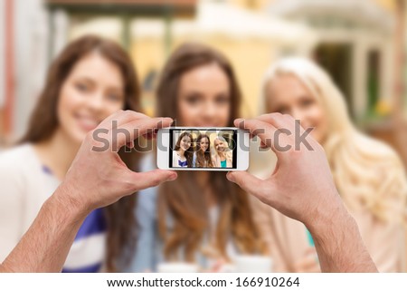 holidays, electronics and tourism concept - close up of man hands taking picture with smartphone camera