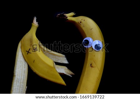 banana with eyes on a black background
