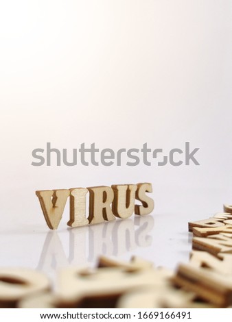 virus on wooden letters with a white background