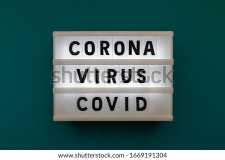 Lightbox with inscription coronavirus covid on dark green background. Words coronavirus covid in light box. Coronavirus disease covid-19. Concept of dangerous viral disease