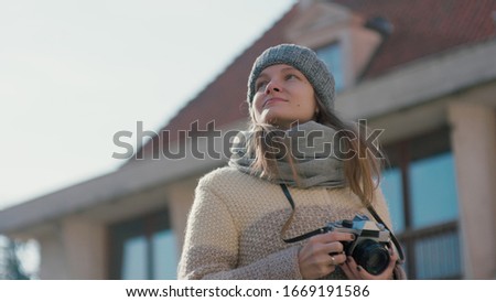 Young Happy Tourist Woman Taking Picture of the Historic Building by the Vintage Photo Camera