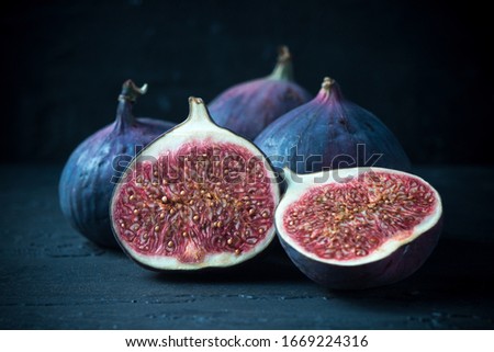 Still life with set of figs fruits. Dark food photography concept. Vegetarian healthy food.