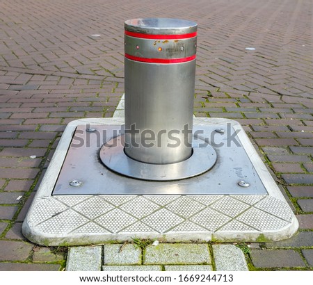 Retractable aluminum obstacle blocking acces in a road Royalty-Free Stock Photo #1669244713