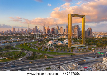 Aerial view of Dubai Frame, Downtown skyline, United Arab Emirates or UAE. Financial district and business area in smart urban city. Skyscraper and high-rise buildings at sunset. Royalty-Free Stock Photo #1669247056