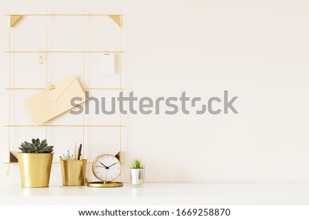 Mock up of woman workplace on light background. Business office desk with gold colors. Modern design. Minimal style.