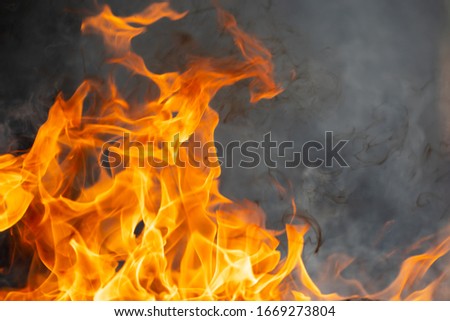 Abstract fire flame glowing burning on black dark background, fireplace for firefighter to safety, photo for creative graphic design wallpaper texture surface, beautiful flame light motion of bonfire 