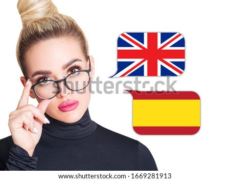 Blonde woman in glasses near dialogue frame with spanish and english flags. Speak language concept. Royalty-Free Stock Photo #1669281913