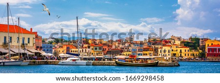 Old port of Chania with flying seagulls. Landmarks of Crete island. Bay of Chania at sunny summer day, Crete Greece. View of the old port of Chania, Crete, Greece. The port of chania, or Hania.  Royalty-Free Stock Photo #1669298458
