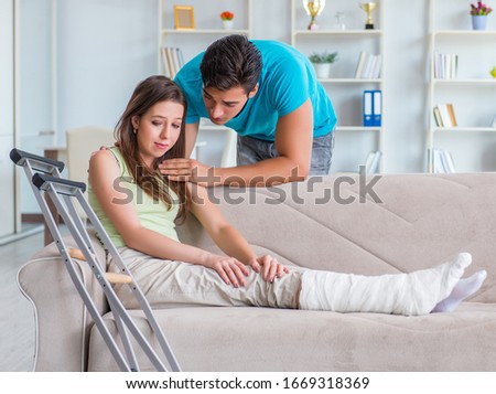 Husband man supporting injured wife Royalty-Free Stock Photo #1669318369