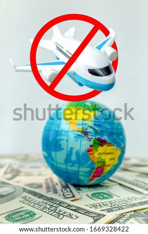 Plane surrounded by forbidden sign over globe amid money dollars