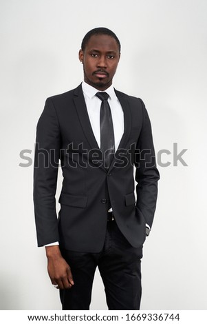 serious african american businessman wearing black suit over grey background with copy space