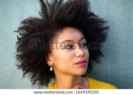 Close up portrait beautiful young african american woman with afro hair looking away