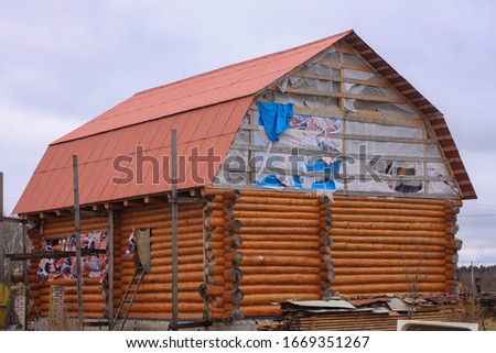 a large wooden log house under construction