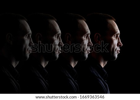 Duplicate portrait of a brutal person the concept of a repeating face on a dark background Royalty-Free Stock Photo #1669363546