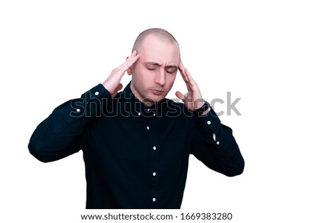 Young man holding his head in pain. Photo of man in shirt and tie grimacing in pain on white background