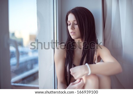 Young woman by the window
