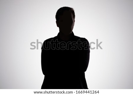 Man silhouette on gray studio wall. Anonym concept Royalty-Free Stock Photo #1669441264