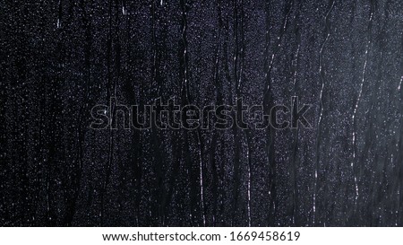 Black wet background raindrops for overlaying on window, concept of autumn weather, background of drops of water rain on glass transparent Royalty-Free Stock Photo #1669458619