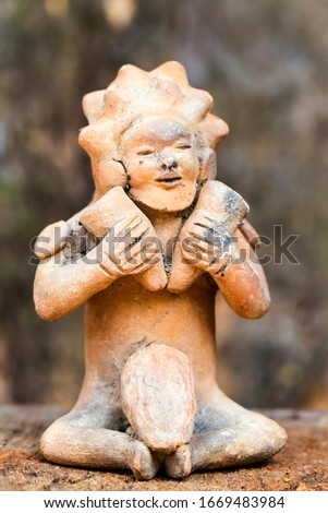 Ancient Tolita culture in Ecuador: Ceramic male figure depicting a woman with two hammers,showcasing the rich heritage of Ecuadorian art from 500 BCE to 500 CE.